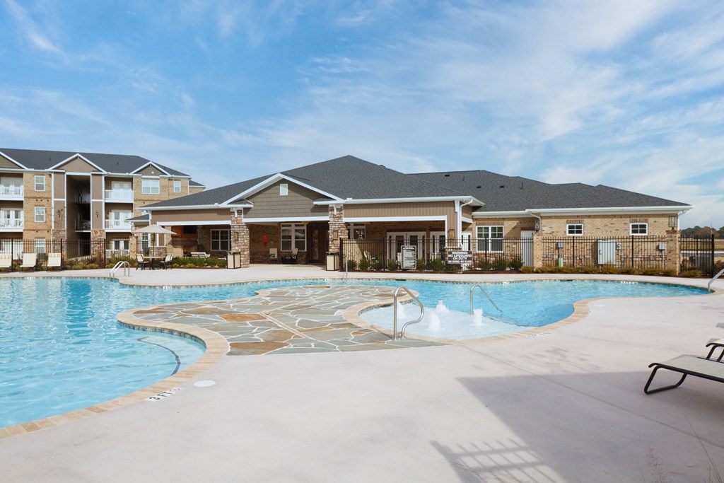 A large swimming pool in front of a building.