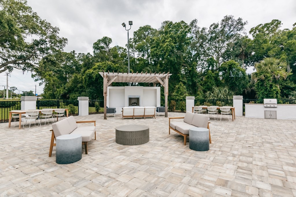 the outdoor patio has a fireplace and seating areas