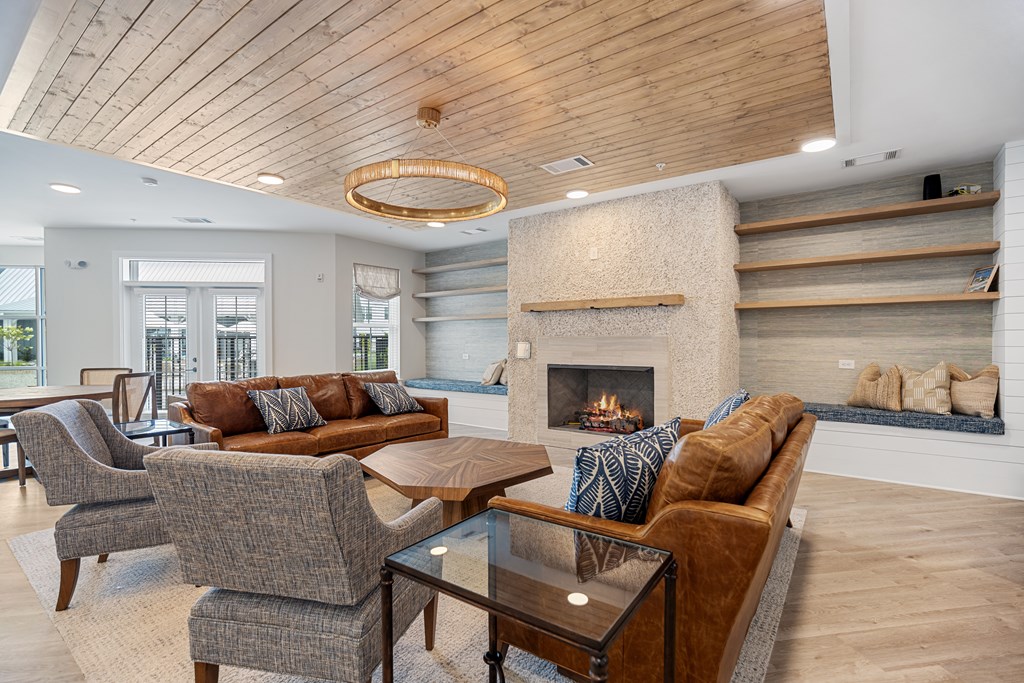Interior of Clubhouse with Modern Living Room, Fireplace and a Glass Coffee Table.