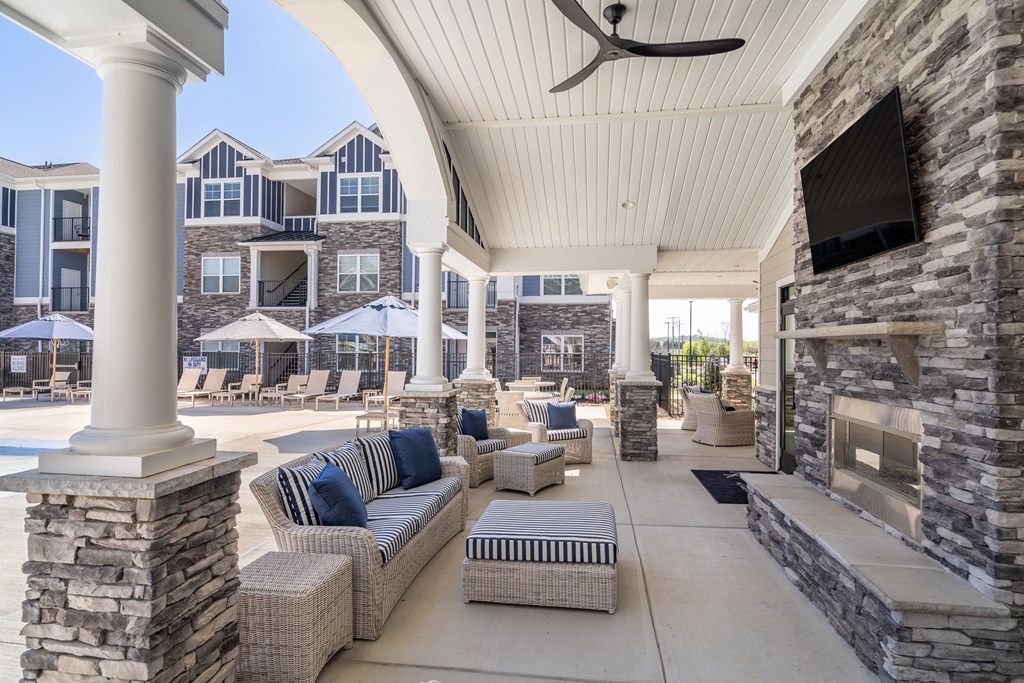 the preserve at ballantyne commons covered patio with couches and a fireplace