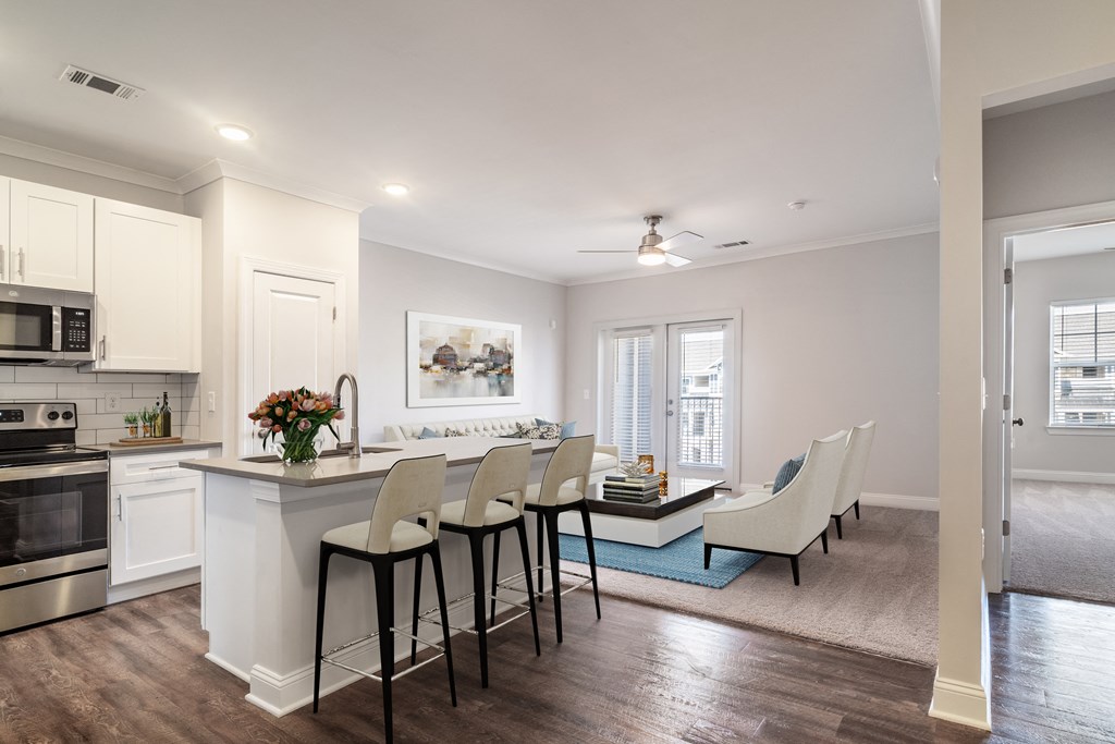an open kitchen and living room with a dining table and chairs