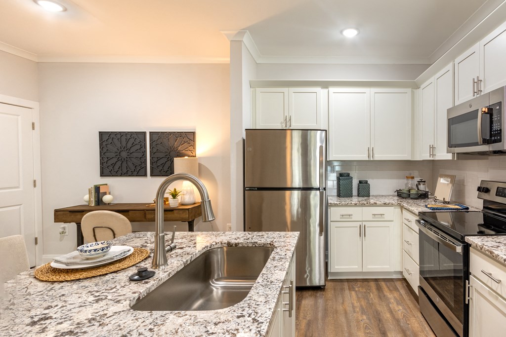 a kitchen with granite counter tops and stainless steel appliances
