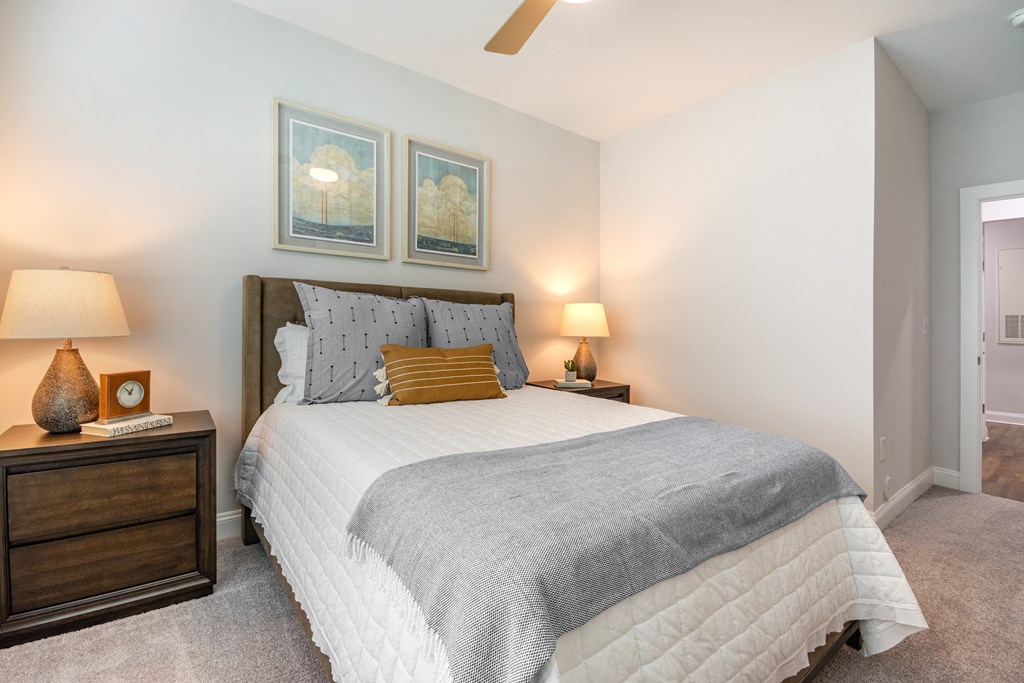 a bedroom with a large bed and two night stands with lamps