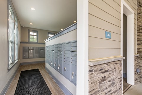 a locker room with blue lockers and a stone wall