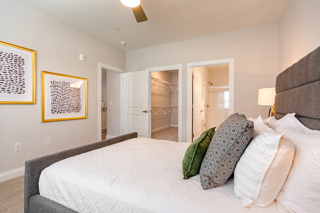 a bedroom with a large white bed and pillows