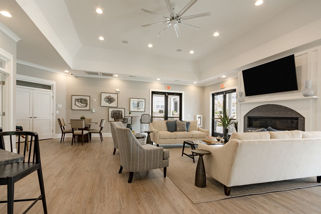 a living room with couches and chairs and a fireplace