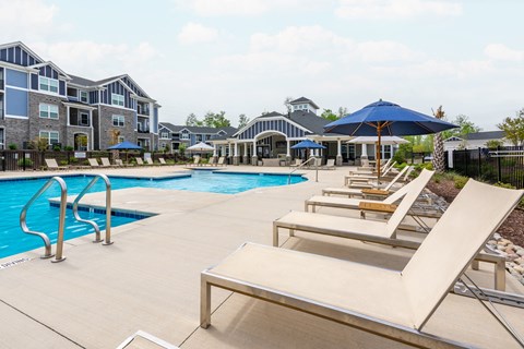 our apartments offer a swimming pool with lounge chairs and umbrellas