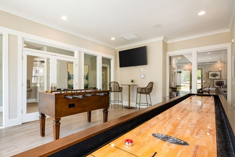a game room with a pool table and a tv