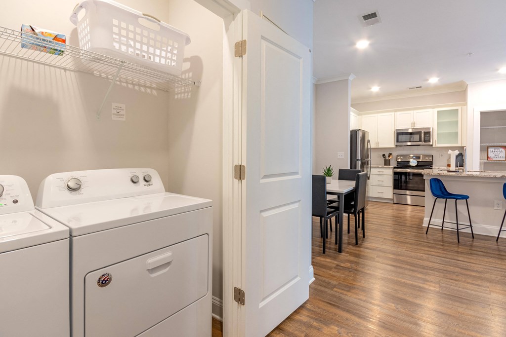 a washer and dryer in a room with a kitchen and a dining room