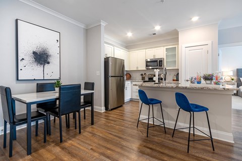 a kitchen and dining area with a table and chairs