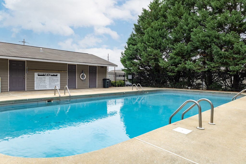 a swimming pool with a building in the background