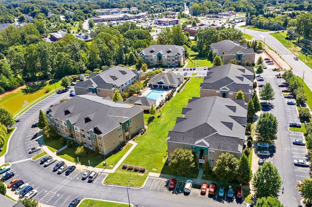 a group of houses in a neighborhood with a swimming pool