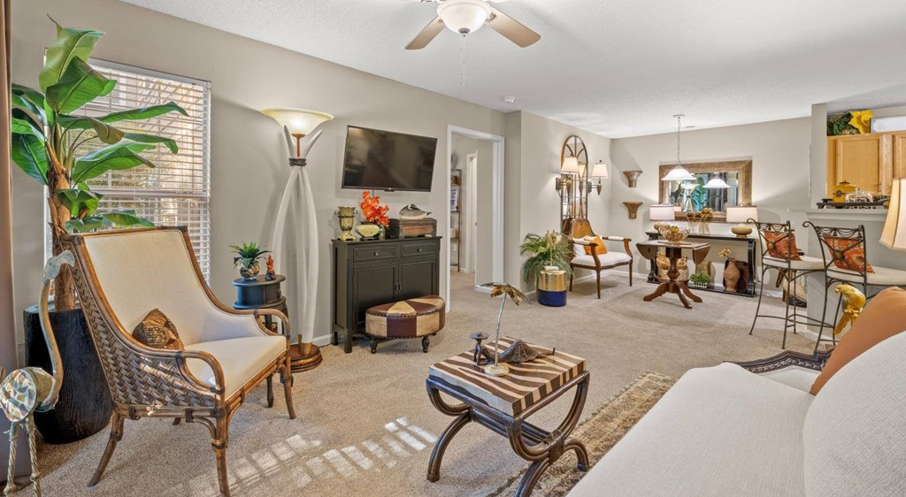 A living room with a white sofa and a wooden coffee table at Palmetto Pointe apartments in Myrtle Beach, SC.