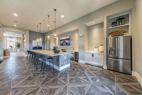 a kitchen with stainless steel appliances and a large island with chairs