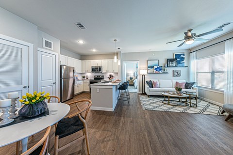 a living room with a kitchen and a dining room