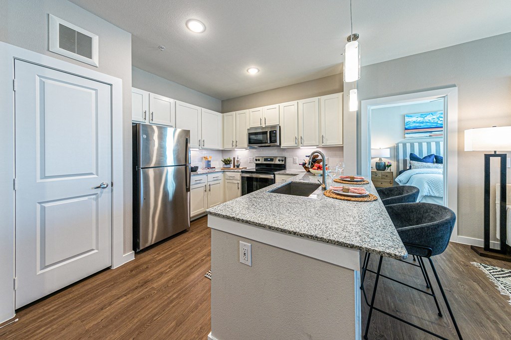 a kitchen with stainless steel appliances and a granite counter top