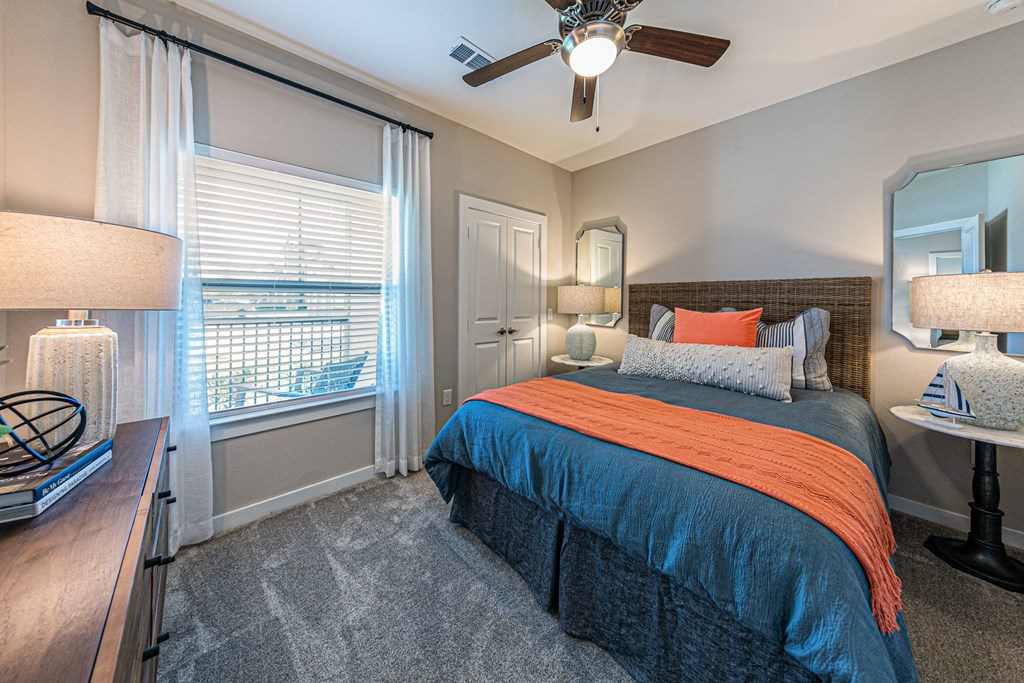 a bedroom with a bed and a ceiling fan