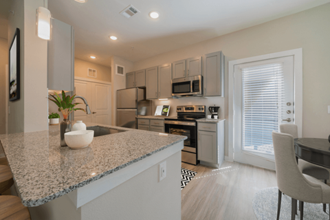 a kitchen with a granite counter top and a sink