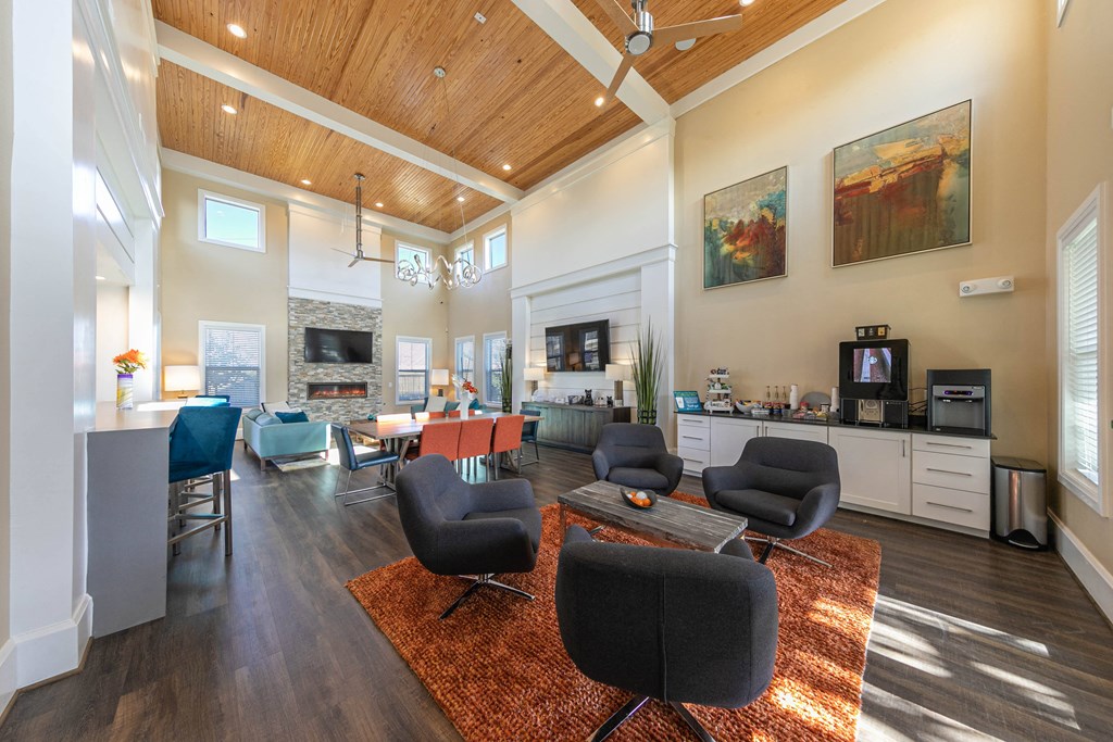 a living room with chairs and a table and a fireplace