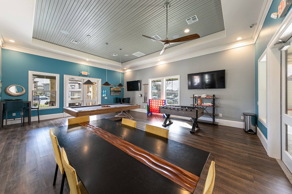 a game room with a pool table and a television