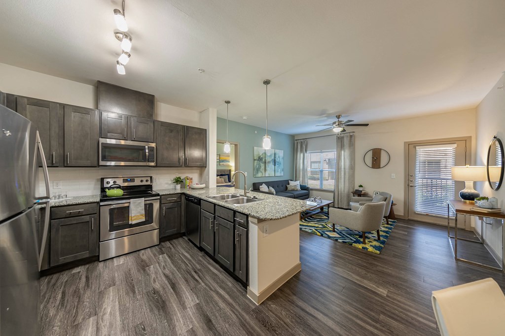 a kitchen with stainless steel appliances and a granite counter top