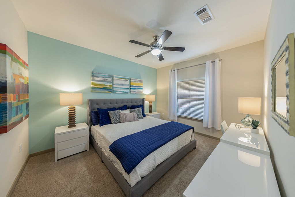 a bedroom with a bed and a ceiling fan