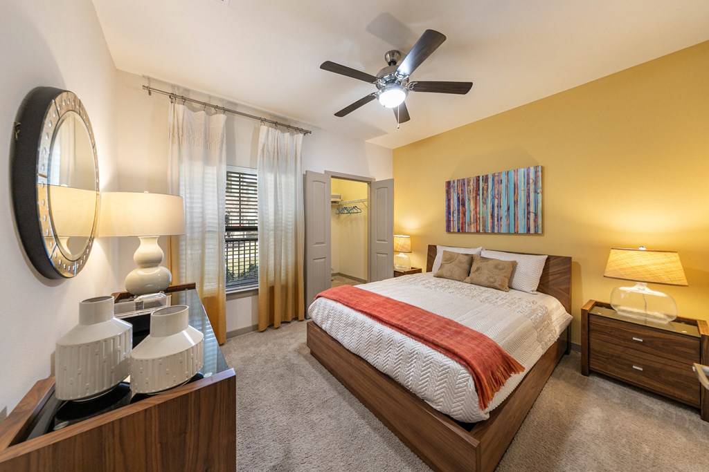 a bedroom with a bed and a ceiling fan