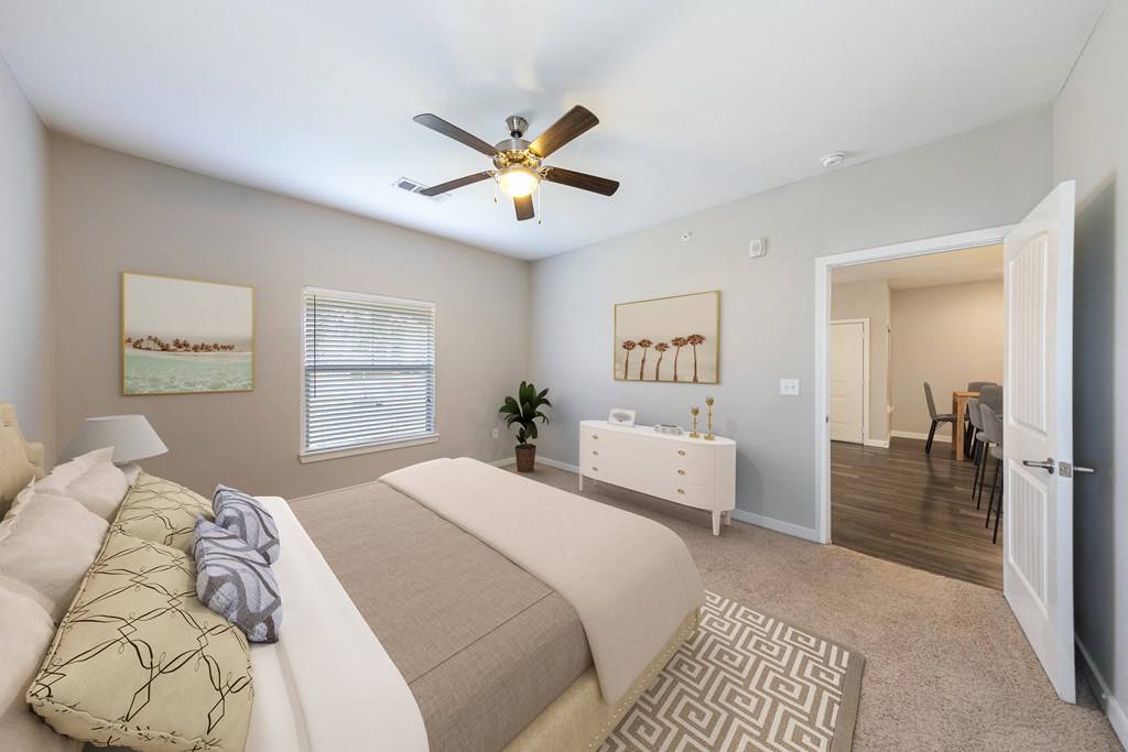 a bedroom with a large bed and a ceiling fan