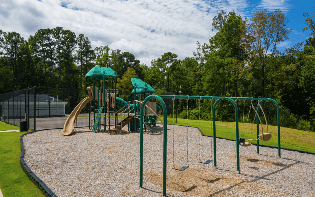a playground with a jungle gym and slides in a park