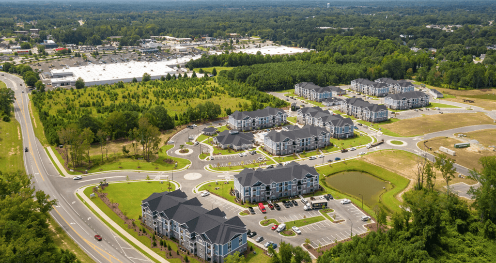 an aerial view of a city with houses and roads