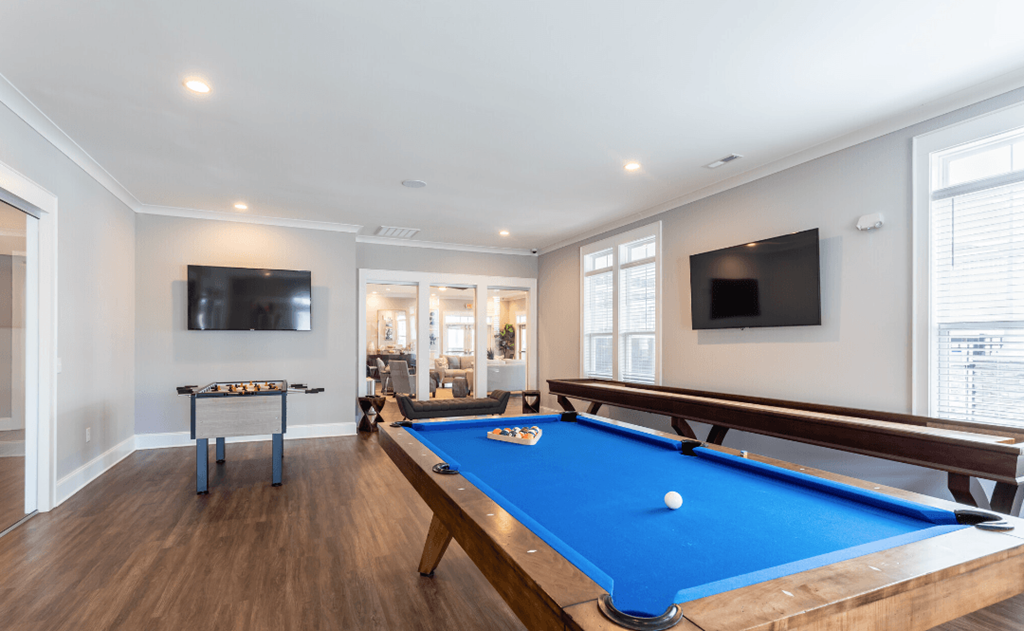 a game room with a pool table and a television