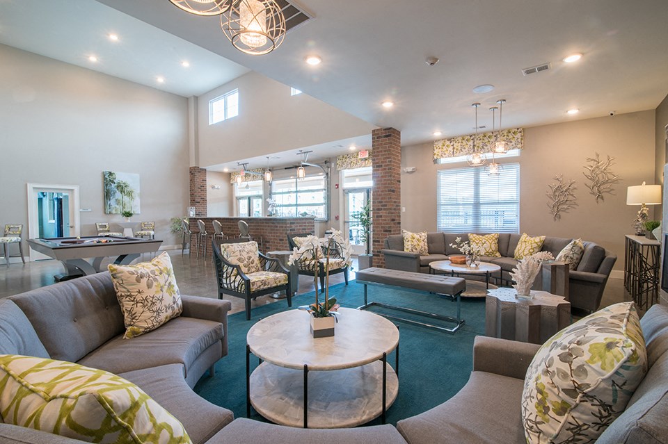 a living room with couches and chairs and a coffee table