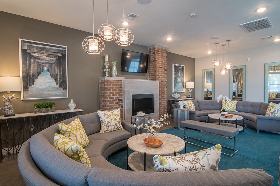 a living room with couches and a fireplace and a television