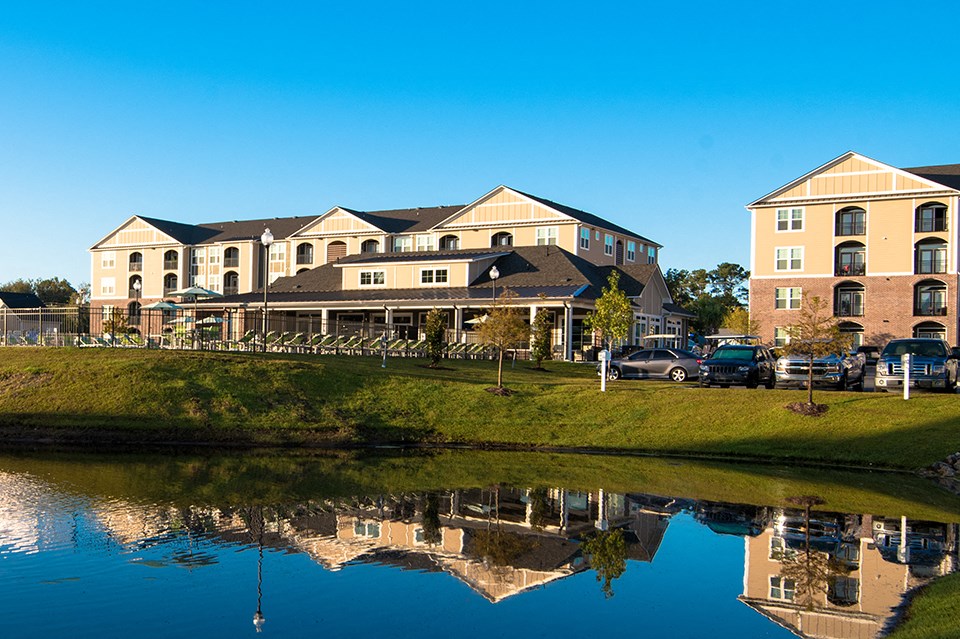 a reflection of a building in a body of water