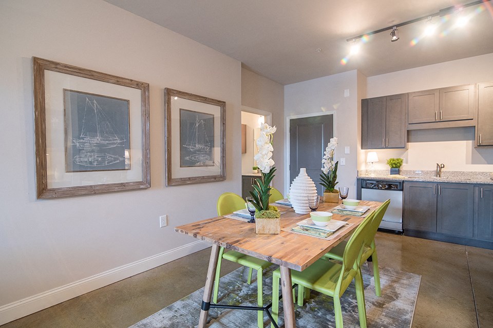 a dining room with a table and chairs next to a kitchen