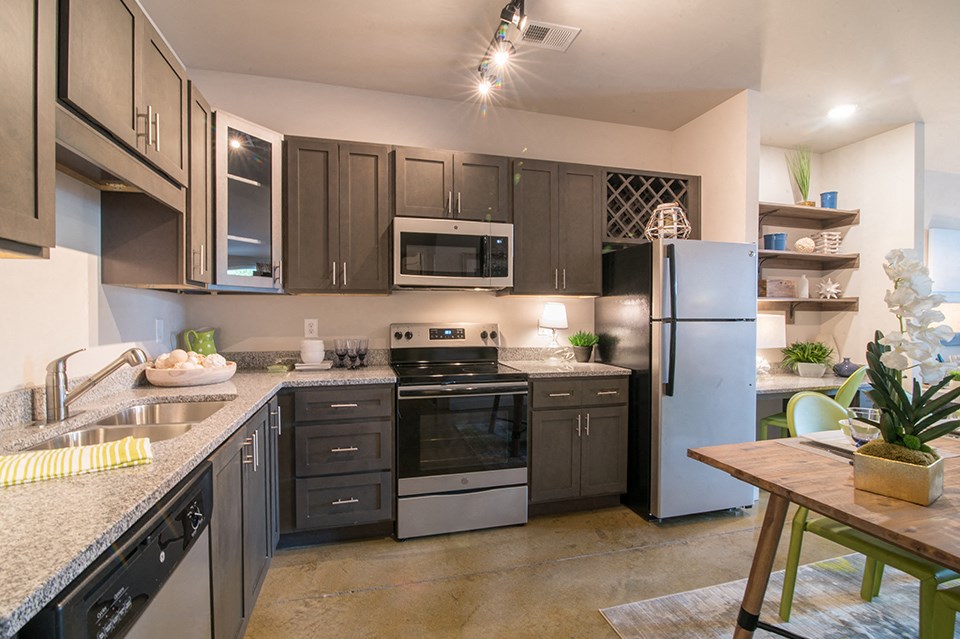 a kitchen with stainless steel appliances and granite counter tops