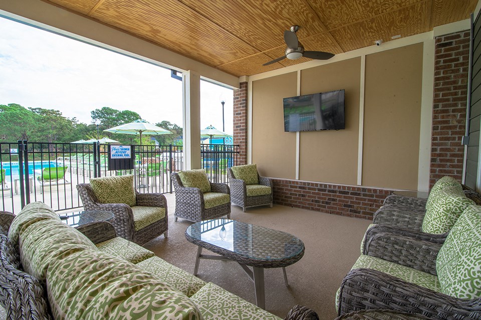 a living room with couches and a table and a balcony
