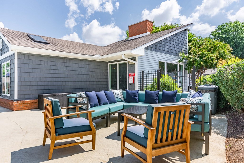 a patio with a table and chairs and a house