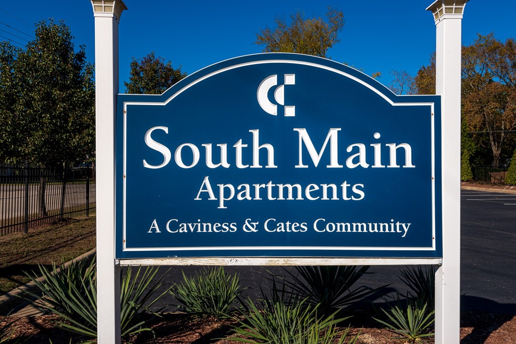 a blue sign that reads south main apartments a carves and cafes community