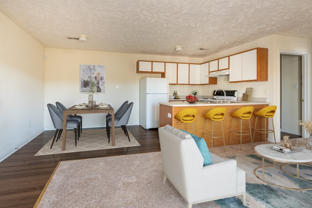 a living room and kitchen with a table and chairs