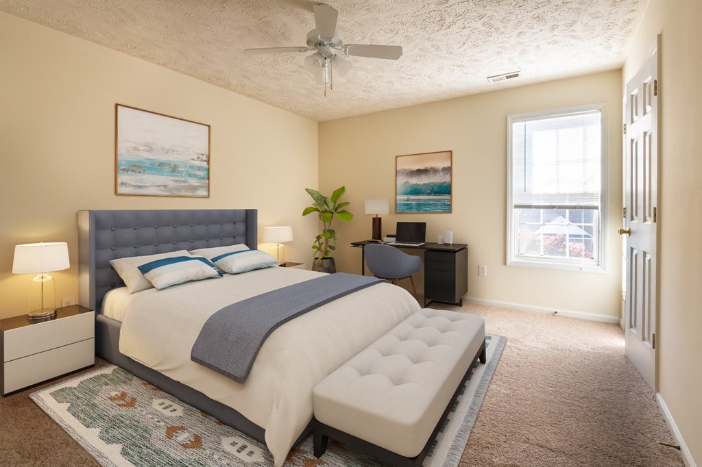 a bedroom with a bed and a ceiling fan