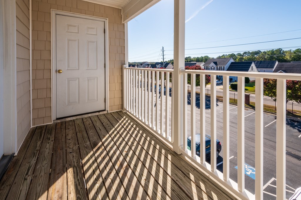 the view from the deck of a home with a white door