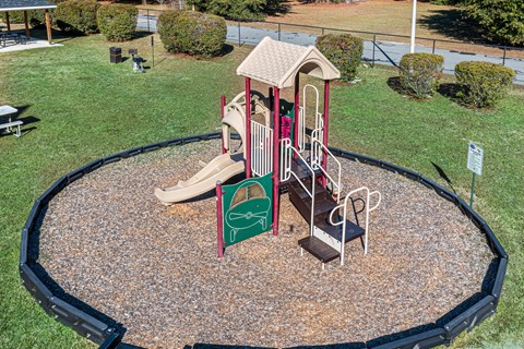a playground with a slide and other toys in a park