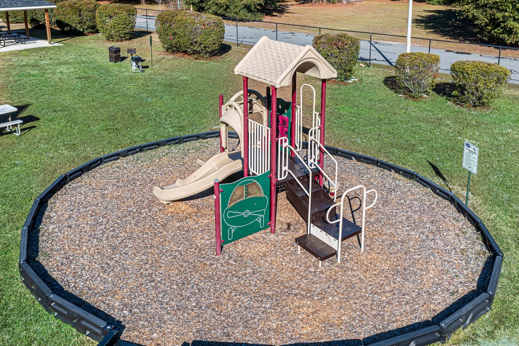 a playground with a slide and other toys in a park