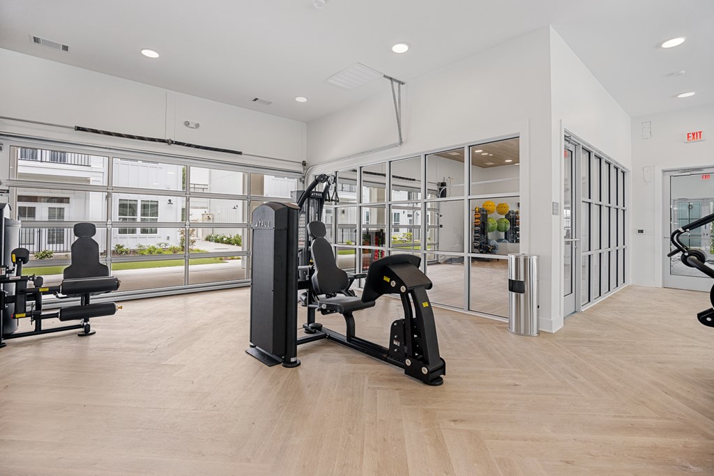 Inside Gym with a Different Equipment Yet Main Focus is on the Bench Press.