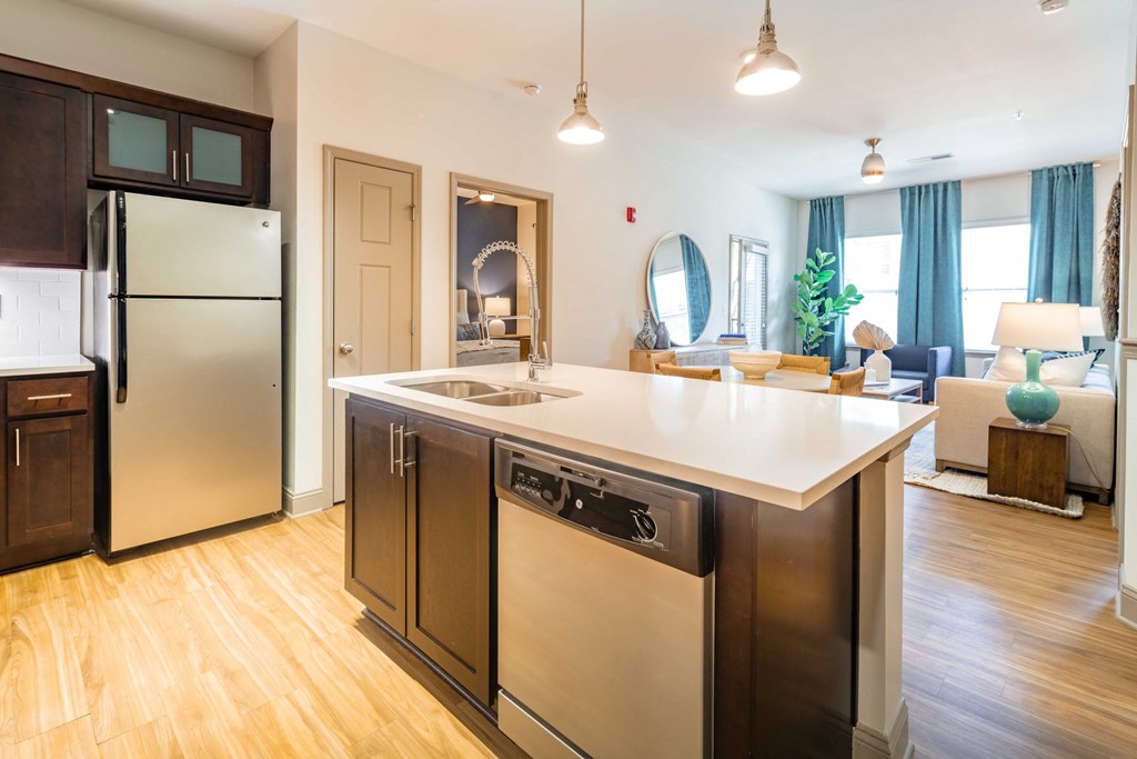 a kitchen with stainless steel appliances and a white counter top