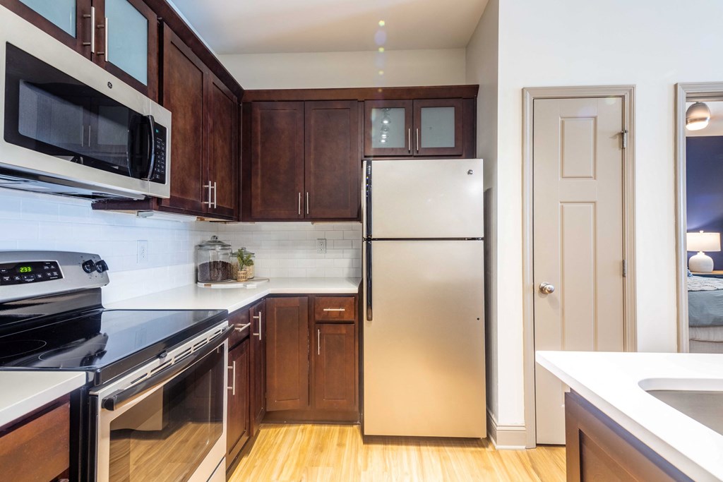a kitchen with stainless steel appliances and wooden cabinets