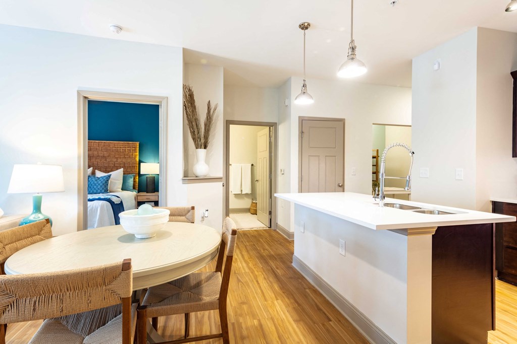 a living room and dining room with a table and a kitchen
