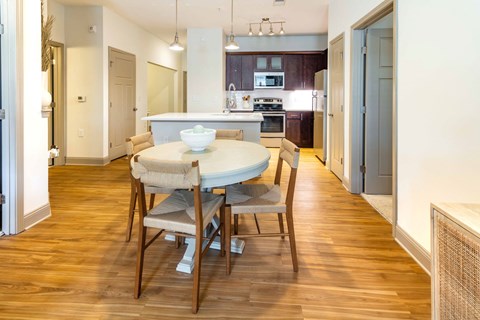 a dining room and kitchen with a table and chairs