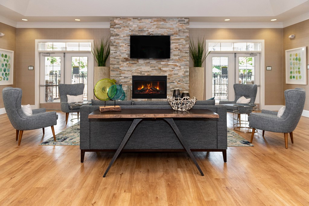 a living room with a fireplace and a tv on the wall